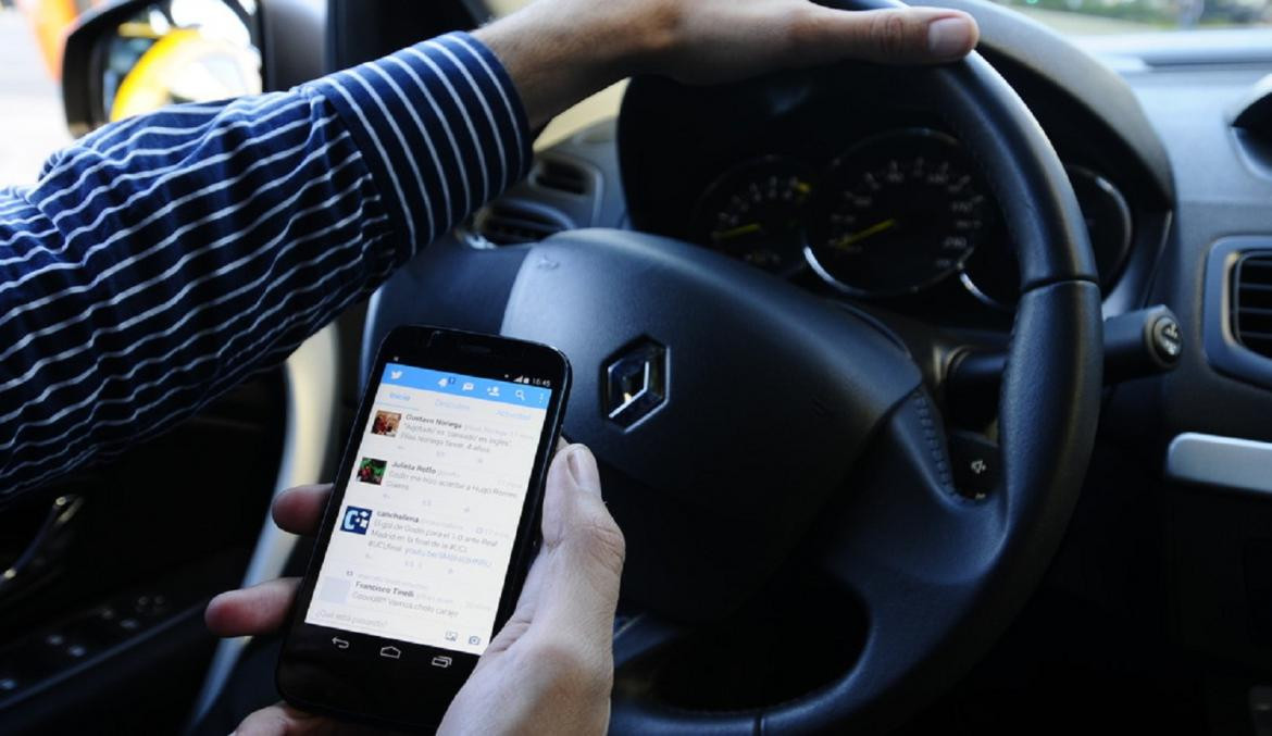 Uso del celular en el auto, maneja usando el celular