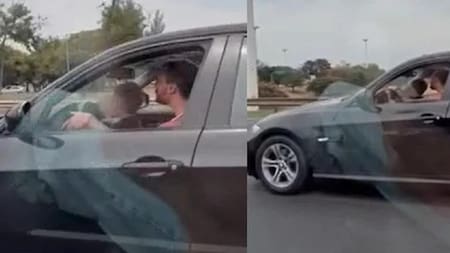 Un hombre manejó con un menor sobre sus piernas. Foto: captura de video