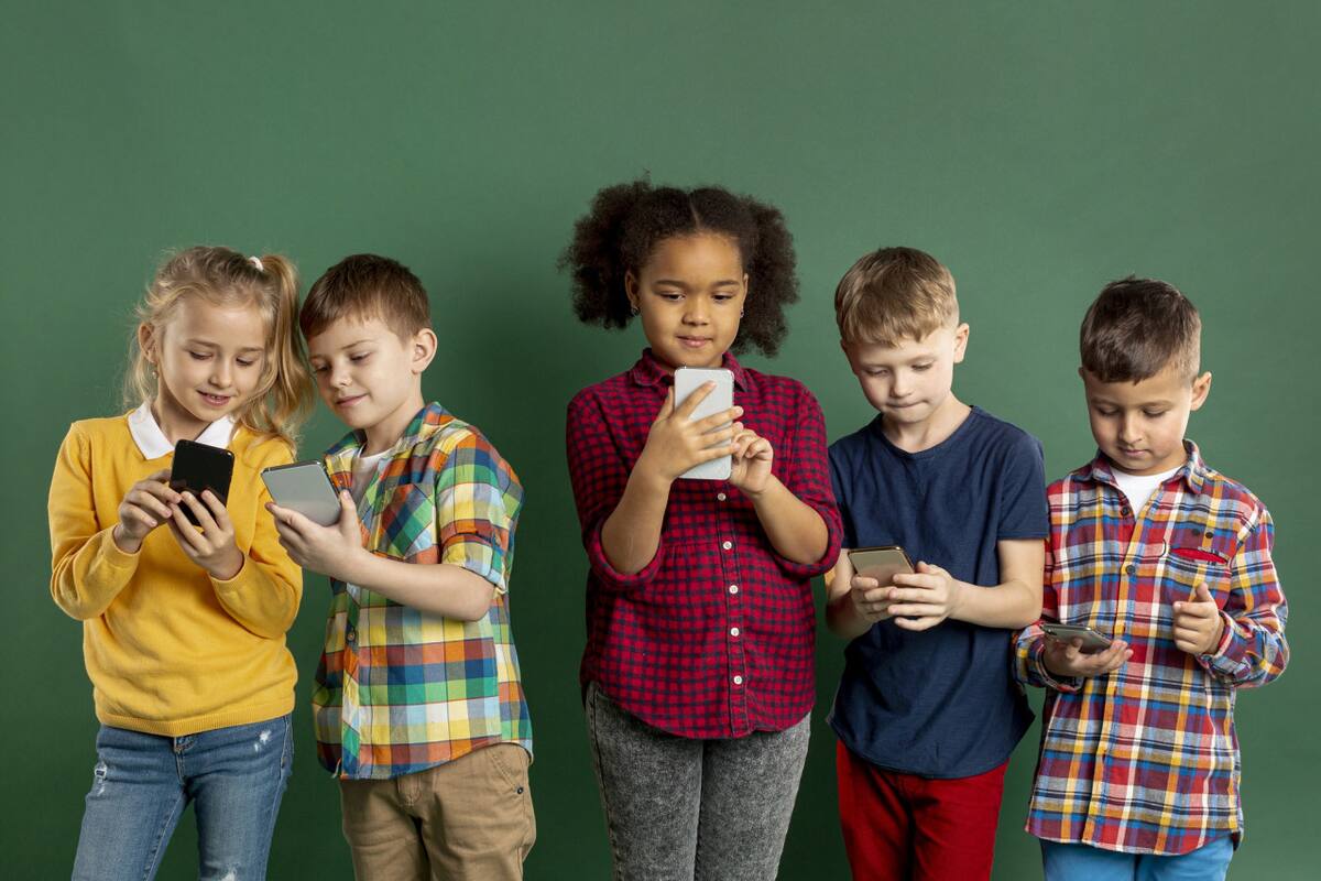 Niños usando el celular. Foto Freepik