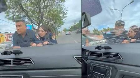 Los agentes sobre el capot. Fotos: captura de video.