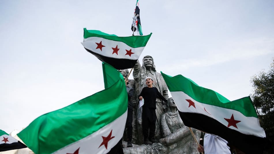 Manifestantes con la nueva bandera de Siria. Foto: Reuters.