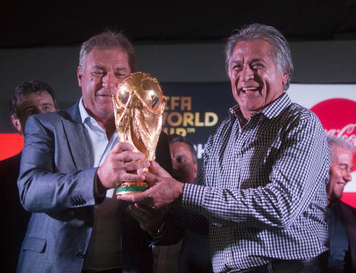 Integrantes del plantel campeón mundial del 78 y 86 posan con la Copa del Mundo en el predio de la AFA en Ezeiza