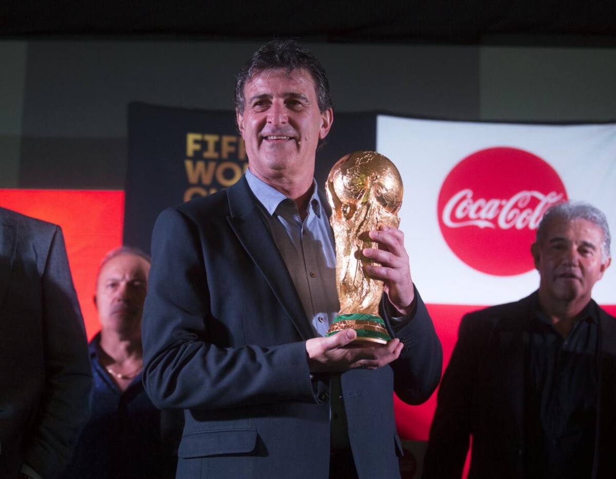 Integrantes del plantel campeón mundial del 78 y 86 posan con la Copa del Mundo en el predio de la AFA en Ezeiza